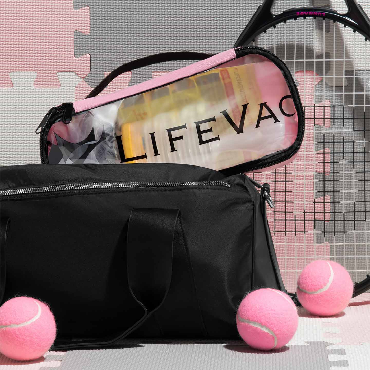 Pink LifeVac Travel kit inside gym bag with tennis racket and tennis balls